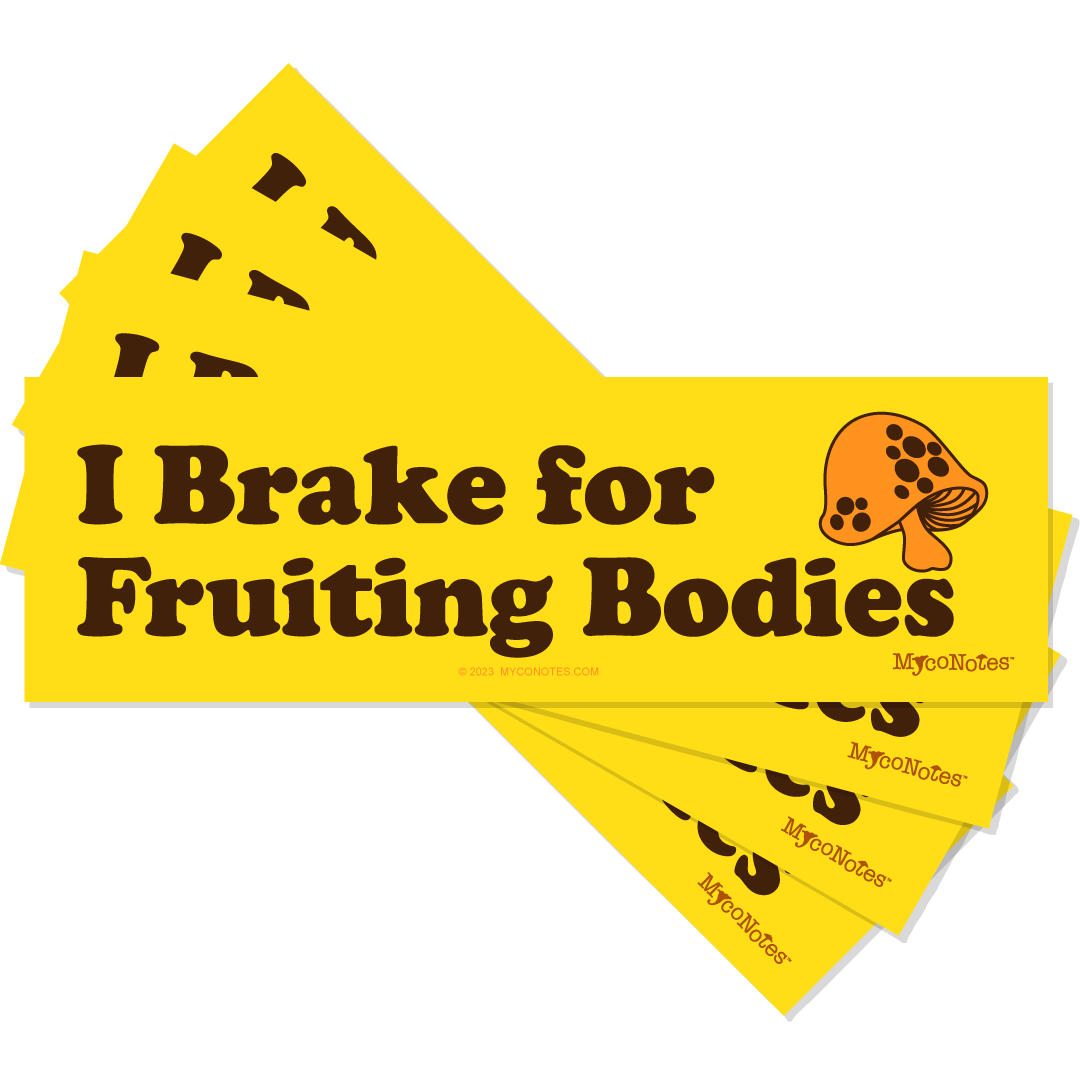 Stack of yellow bumper stickers with 'I Brake for Fruiting Bodies' text and mushroom illustration