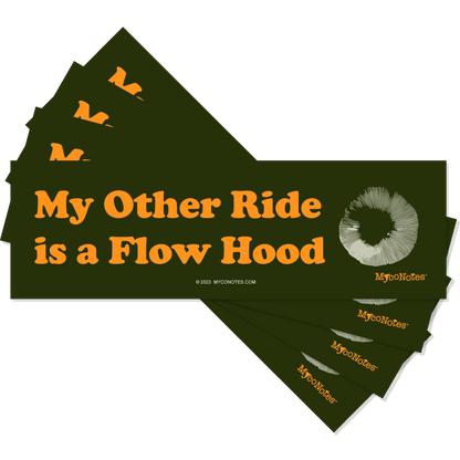 Stack of green bumper stickers with orange text 'My Other Ride is a Flow Hood' and a spore print illustration